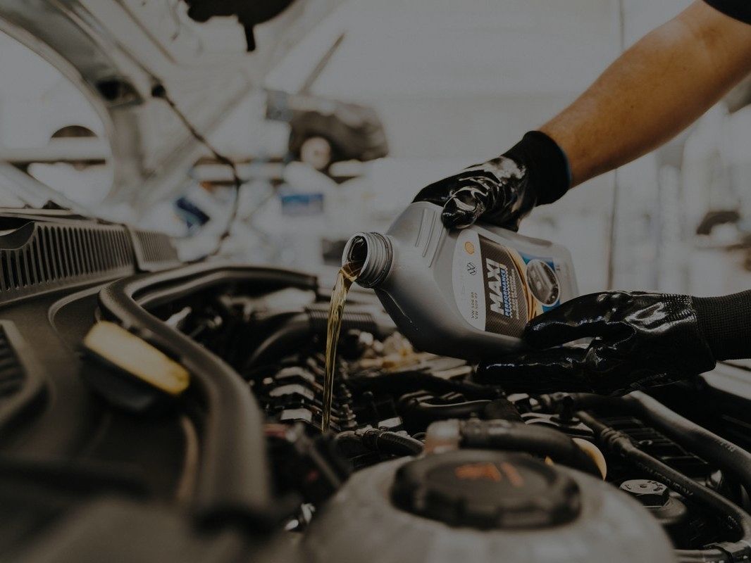 Fresh oil being poured into an engine during a service